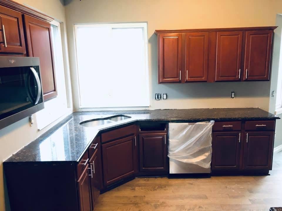 Cherry cabinet kitchen with dark granite